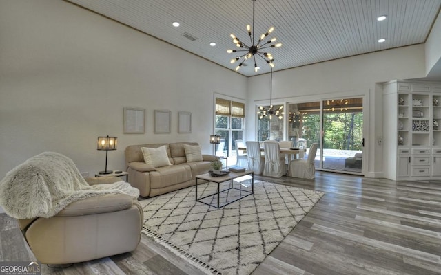 living room featuring a chandelier, a high ceiling, wood ceiling, and hardwood / wood-style floors