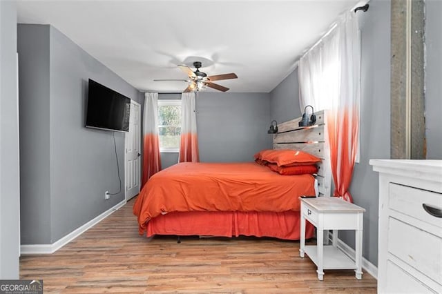 bedroom with ceiling fan and light hardwood / wood-style floors