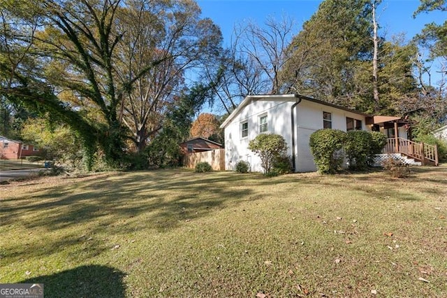 view of side of home featuring a yard