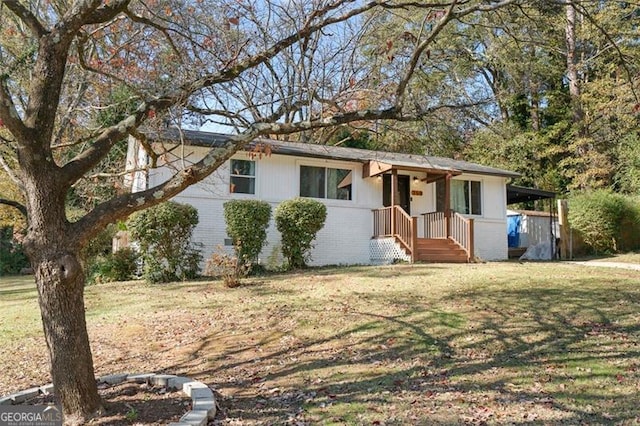 ranch-style house with a front yard and a carport