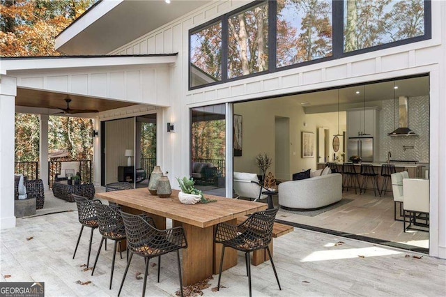 view of patio / terrace with ceiling fan and an outdoor bar