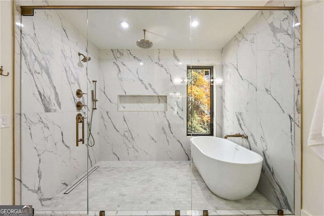 bathroom featuring separate shower and tub and tile walls