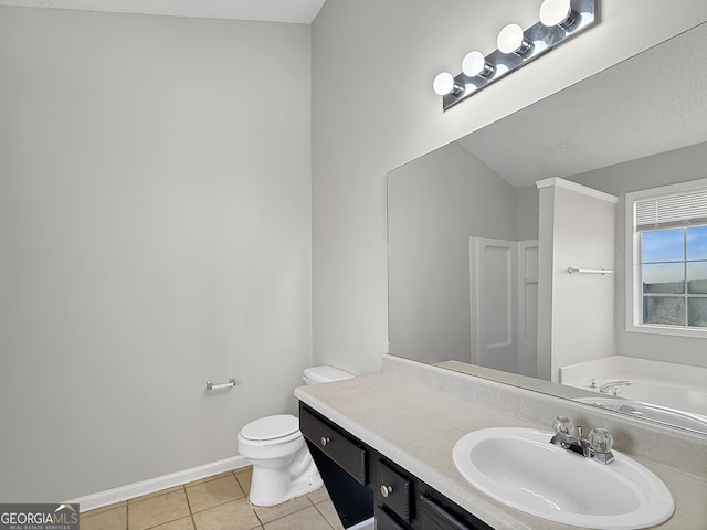 bathroom with vanity, a textured ceiling, a bath, tile patterned flooring, and toilet