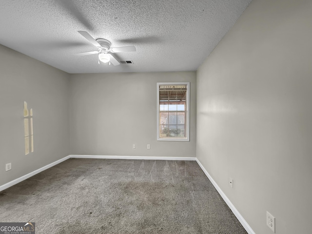 carpeted empty room featuring a textured ceiling and ceiling fan