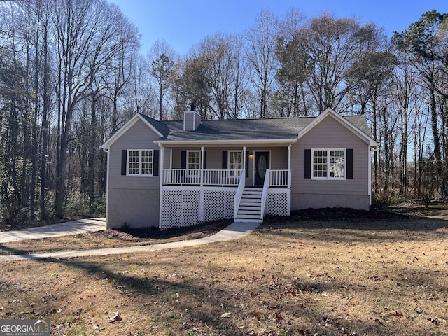 ranch-style house with cooling unit, a front lawn, and a porch