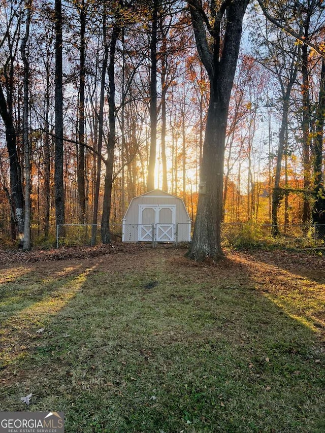 yard at dusk with a storage shed