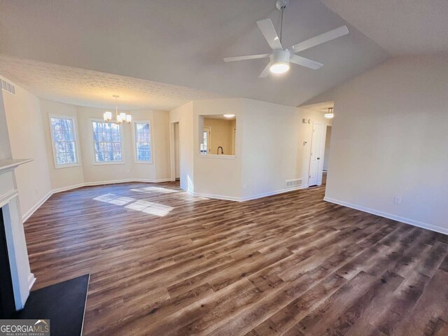 unfurnished living room featuring a textured ceiling, ceiling fan with notable chandelier, dark hardwood / wood-style floors, and lofted ceiling