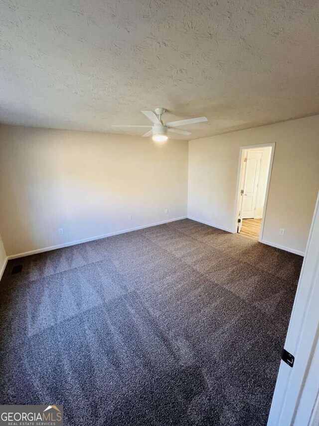 carpeted spare room featuring a textured ceiling