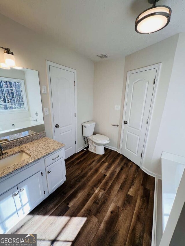 bathroom with hardwood / wood-style floors, vanity, separate shower and tub, and a textured ceiling