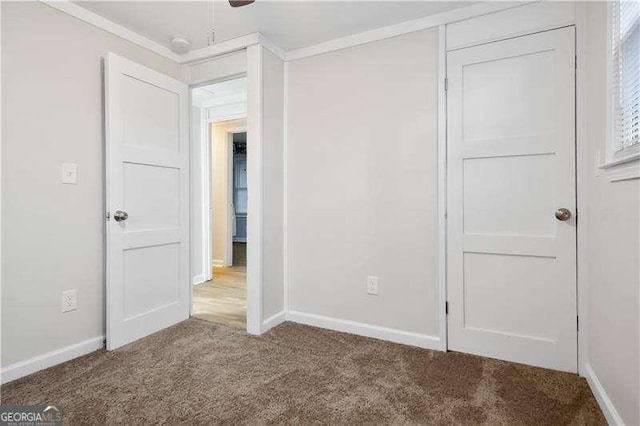 unfurnished bedroom with carpet flooring, ceiling fan, and ornamental molding