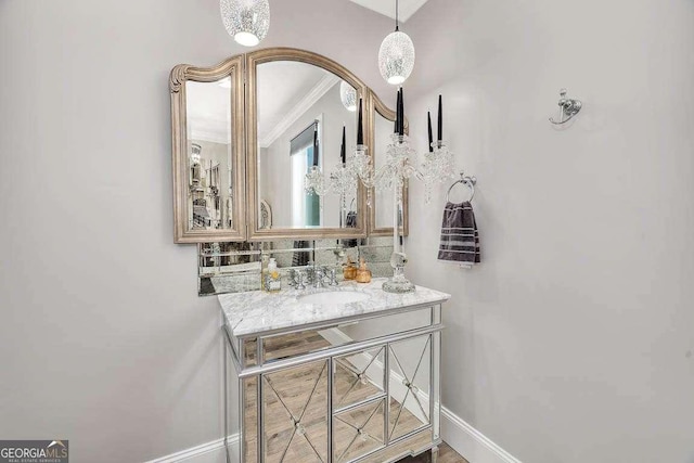 bathroom with decorative backsplash, vanity, and ornamental molding