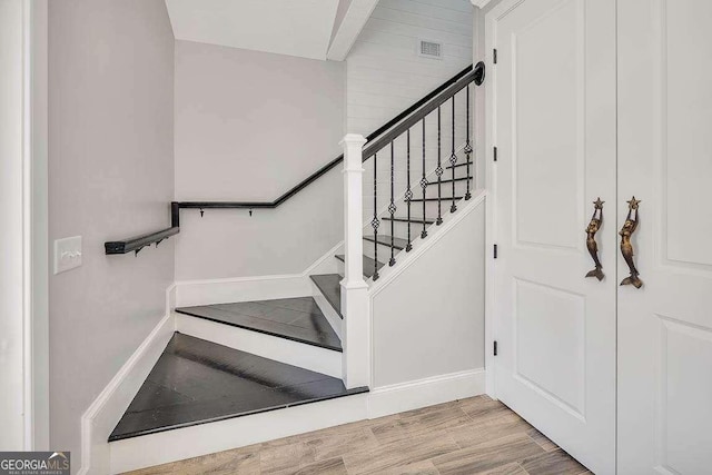 stairway featuring wood-type flooring