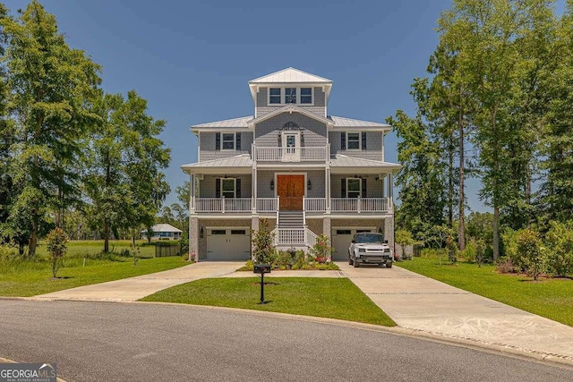 view of front facade with a garage, a porch, and a front yard