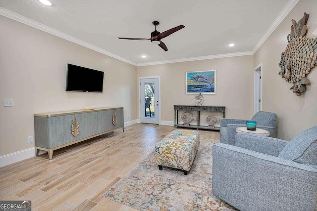 living room featuring ceiling fan, wood-type flooring, and crown molding