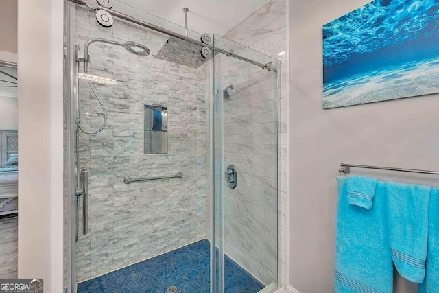 bathroom with a shower with door