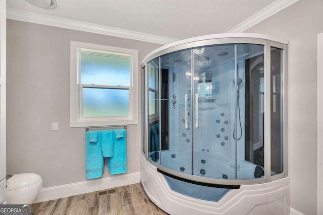 bathroom with crown molding, toilet, bath / shower combo with glass door, and hardwood / wood-style flooring