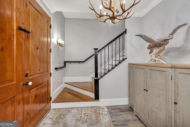 entrance foyer featuring a chandelier, hardwood / wood-style flooring, and ornamental molding