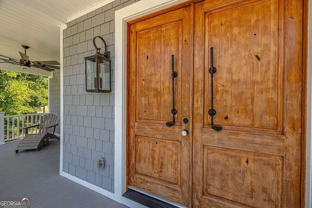 doorway to property featuring ceiling fan