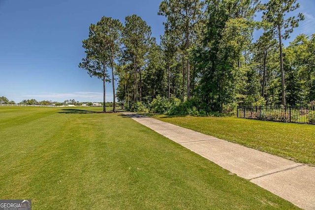 view of property's community featuring a yard