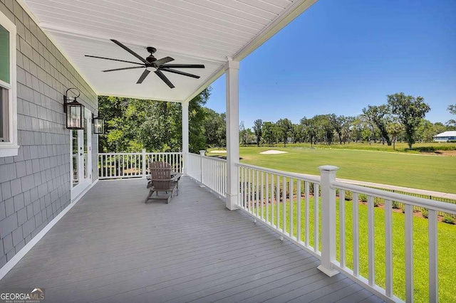 deck with covered porch, ceiling fan, and a lawn