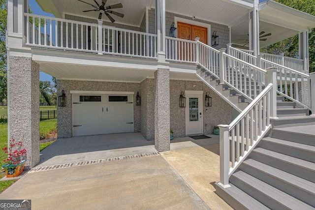 exterior space with covered porch, ceiling fan, and a garage