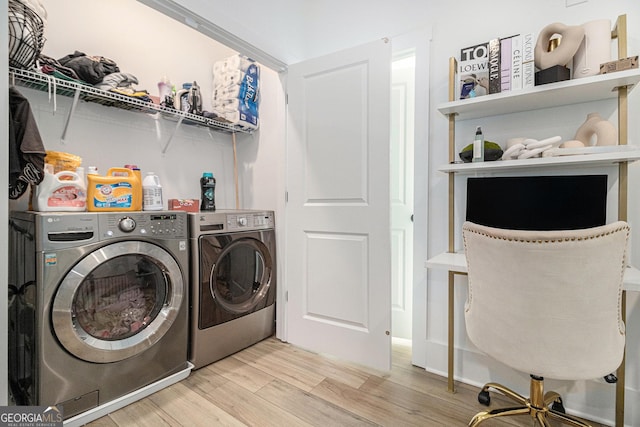 washroom featuring washer and clothes dryer and light hardwood / wood-style floors