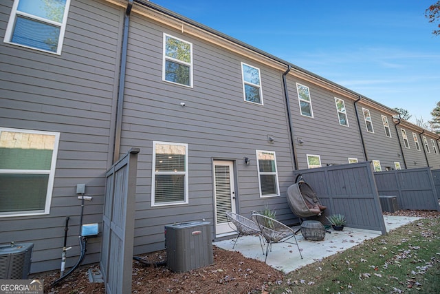 rear view of house featuring a patio and central AC