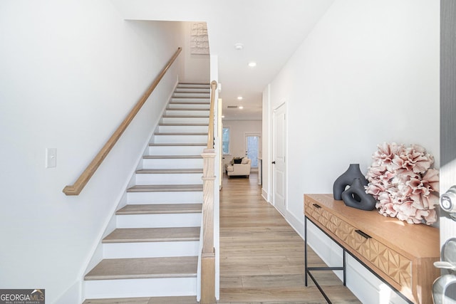 stairway with hardwood / wood-style flooring