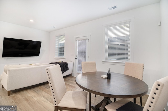 dining room featuring plenty of natural light and light wood-type flooring