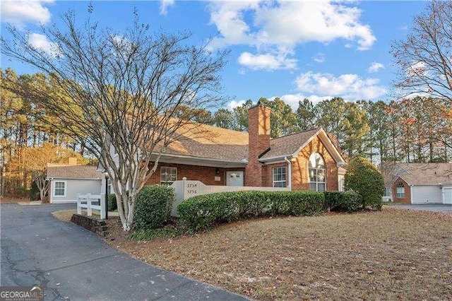 ranch-style house featuring an outbuilding