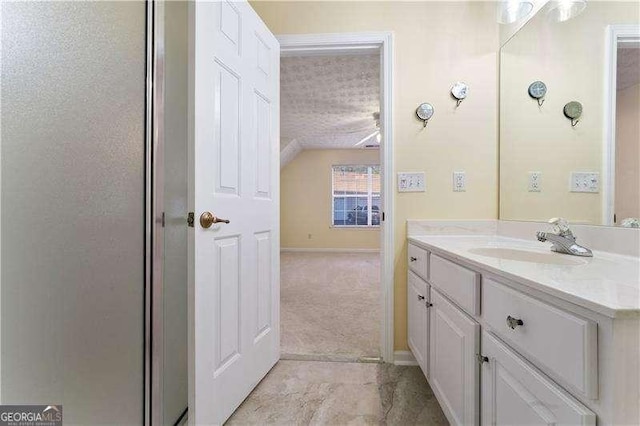 bathroom with a shower with door and vanity