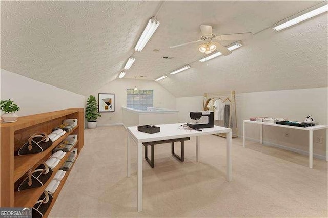 interior space with lofted ceiling, ceiling fan, light carpet, and a textured ceiling