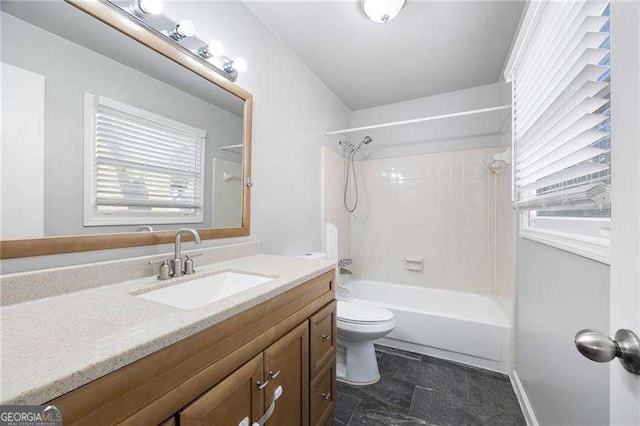 full bathroom with vanity, tiled shower / bath combo, and toilet