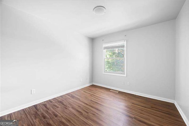 empty room featuring dark hardwood / wood-style floors