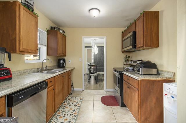 kitchen with sink, light tile patterned floors, and appliances with stainless steel finishes