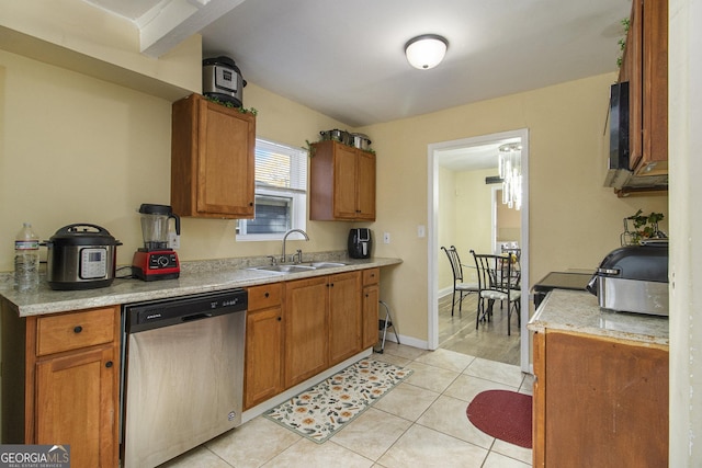 kitchen featuring dishwasher, light tile patterned floors, and sink