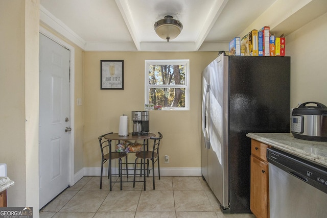 kitchen featuring light stone counters, light tile patterned flooring, and stainless steel appliances