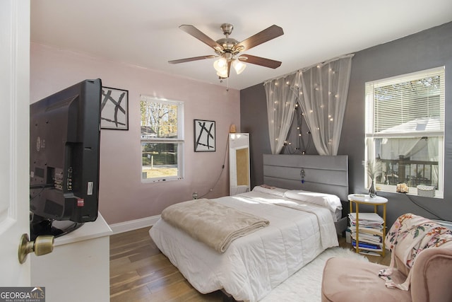 bedroom featuring hardwood / wood-style floors and ceiling fan