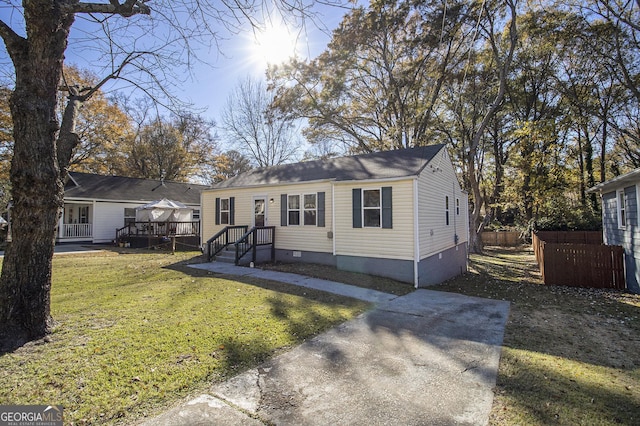 view of front facade featuring a front yard and a deck