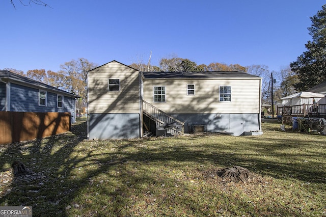 rear view of property featuring a lawn