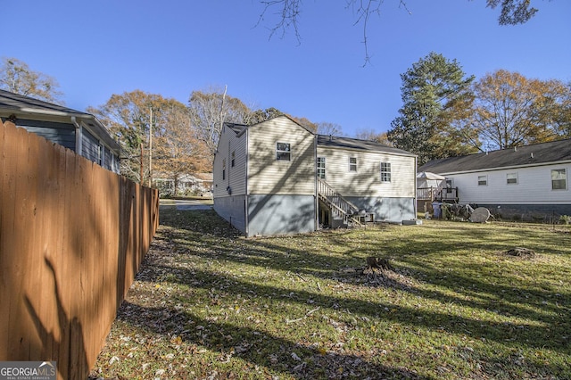 view of property exterior featuring a lawn