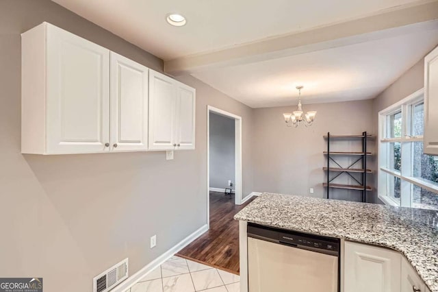 kitchen featuring light hardwood / wood-style flooring, stainless steel dishwasher, light stone countertops, white cabinetry, and a chandelier