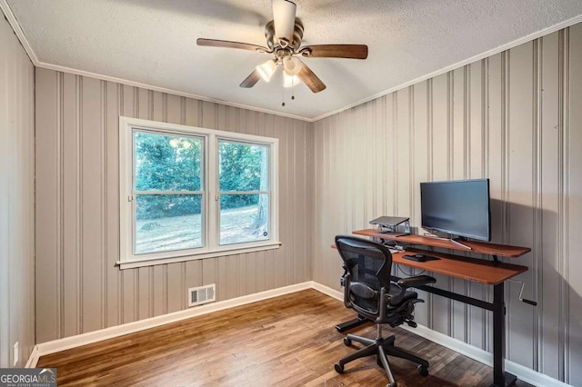 office with hardwood / wood-style floors, ceiling fan, ornamental molding, and a textured ceiling