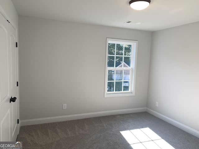 unfurnished room featuring carpet flooring