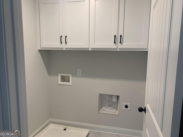 laundry room featuring hookup for a washing machine, hookup for an electric dryer, and cabinets