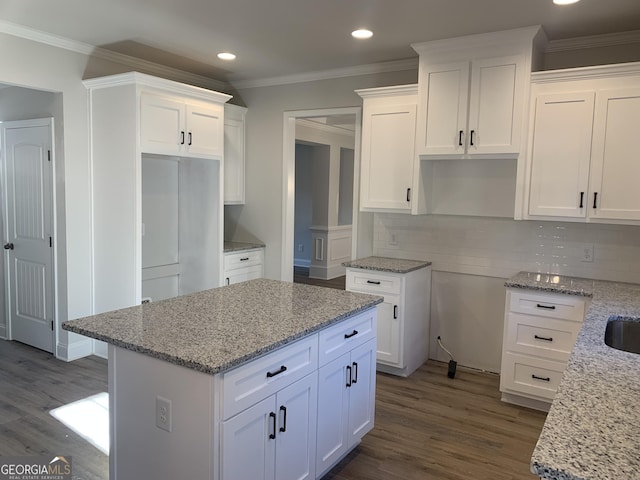 kitchen with light stone counters and white cabinets