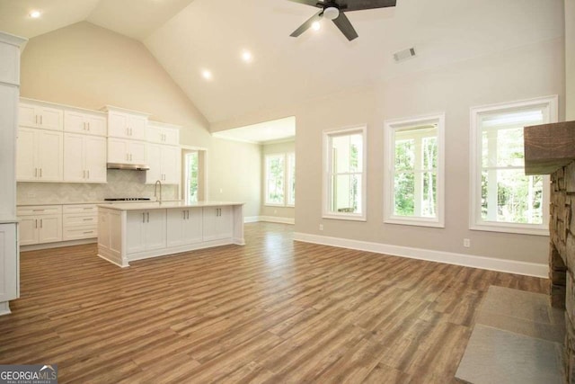 unfurnished living room featuring ceiling fan, light hardwood / wood-style flooring, and high vaulted ceiling