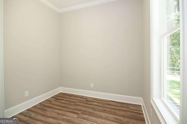 empty room featuring dark hardwood / wood-style floors and ornamental molding