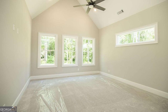 spare room featuring light colored carpet, high vaulted ceiling, and ceiling fan