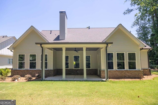 back of property with a lawn, a patio area, and ceiling fan